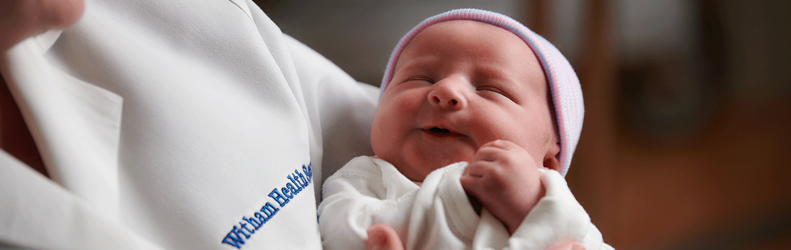 Witham Obstetrics and Gynecology Provider holding a newborn