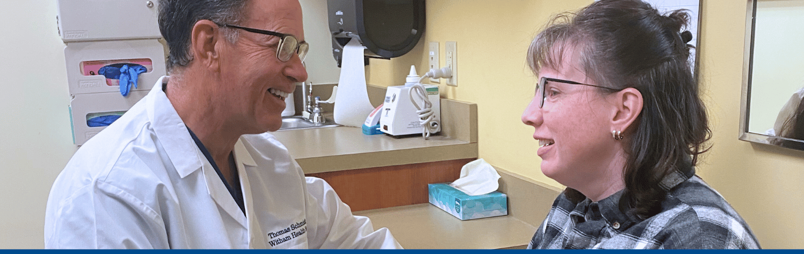 R. Thomas Schmidt, M.D., Indiana's first surgical breast oncologist meets with a patient